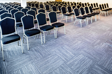 Chairs in a row in empty conference hall.