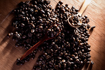 Coffee beans in wooden spoon close up