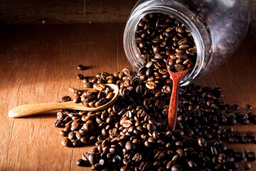 Coffee beans in wooden spoon close up