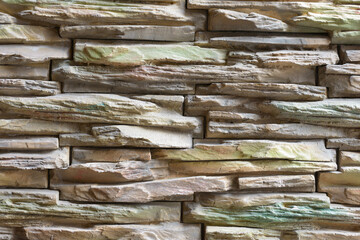 Portrait of stone wall made of thin bricks stacked together