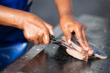 Fresh fish being cut, filleted and prepared