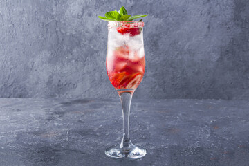 Cooling strawberry Sangria with wine, strawberry, ice cubes in champagne glass. Refreshing summer...