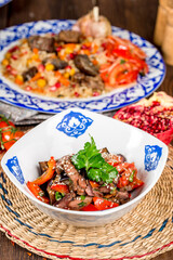 Baked eggplant salad with vegetables in a plate with a pattern