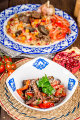 Baked eggplant salad with vegetables in a plate with a pattern