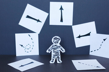 Choice concept, paper man and drawn arrows.