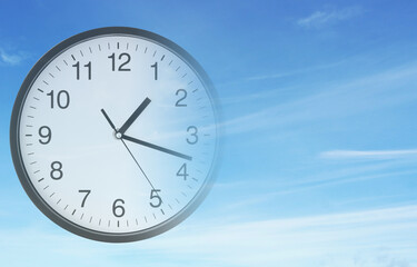 Time passing concept, clock on blue sky background