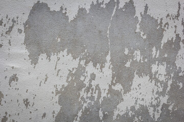Background texture of the old cracked wall with peeling paint and plaster
