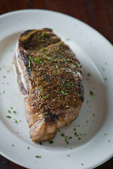 Steak. Grass-fed skirt steak, grilled to a medium rare and served with a garlic herb butter sauce and paired with roasted potatoes and Brussels sprouts. Classic American steakhouse favorite.