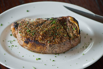 Steak. Grass-fed skirt steak, grilled to a medium rare and served with a garlic herb butter sauce and paired with roasted potatoes and Brussels sprouts. Classic American steakhouse favorite.