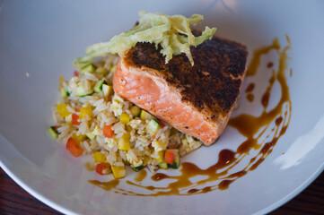 Pan roasted Cajun seasoned salmon fillet. Served with rice pilaf, organic steamed vegetables, bell peppers, squash, carrots and zucchini. Classic American diner lunch favorite.