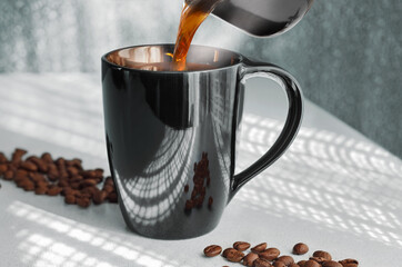 Pour hot coffee from the cezve into the Cup, steam rises. Against the background of openwork...
