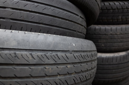 old used car tires stacked in piles