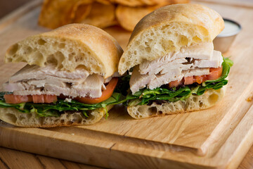 Chicken sandwiches served on toasted whole grain bread with melted Swiss cheese, mayonnaise and seasoned salt and pepper.  Classic American restaurant or diner lunch or brunch sandwich favorite.