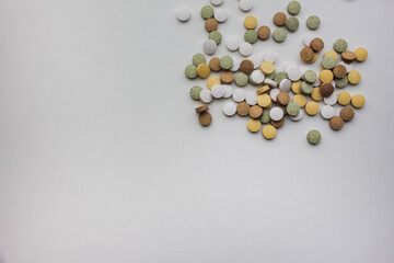 Supplements lie on the surface of the table. Top view. White background. Place for text. Vitamins and food additives have natural plant components and healthy nutrients.