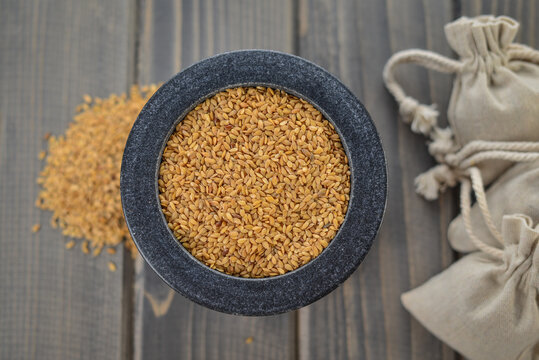 Linseed In Granite Bowl On Wooden Table