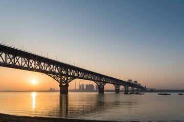 Fototapeta na wymiar jiujiang yangtze river bridge in sunrise