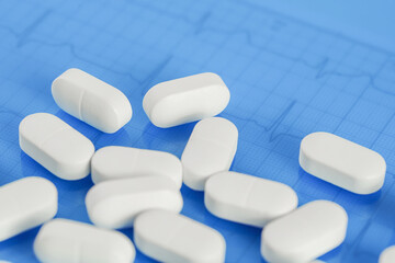 Background of white tablets or pills on the table. Medicine and pharmacy