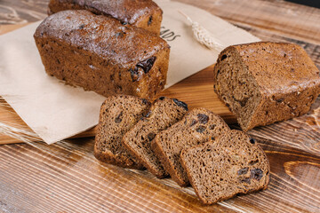 Fresh crunchy bread loafs and pieces on the wooden background