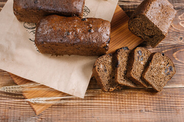Fresh crunchy bread loafs and pieces on the wooden background