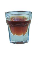 A glass of cognac on a white background is shot very close up