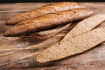 Tasty french baguettes on the wooden background. Top view