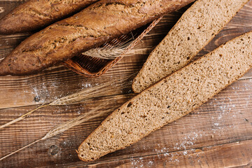 Tasty french baguettes on the wooden background. Top view