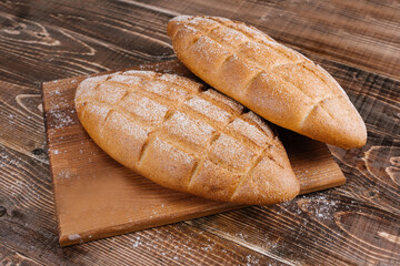 fresh baked bread loafs on the wooden background