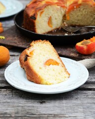 Cake with apricots on a wooden table in the garden, still life