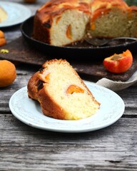 Cake with apricots on a wooden table in the garden, still life