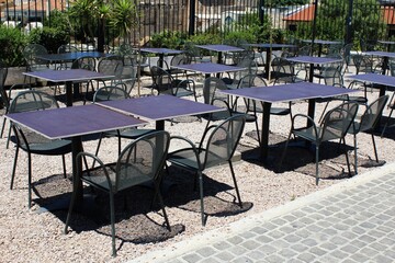 Greece, Athens, June 28 2020 - Empty chairs and tables of a traditional restaurant in the touristic district of Plaka. 