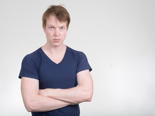 Portrait of young handsome man with arms crossed