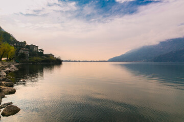 Rose sunset in the evening. Small town Verceia in Lombardy, northern Italy in the summer. Beautiful mountain lake lago di Mezzola. Mountains and lake.