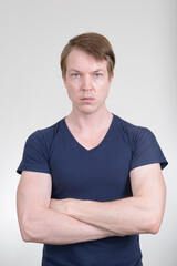 Portrait of young handsome man with arms crossed