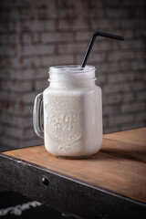 glass of milk and a spoon