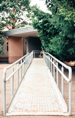Metal ramp to support wheelchair users. Accessible environment for people with disabilities.