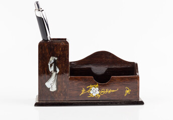 pen in wooden box on white background