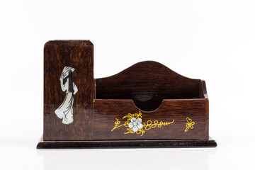 pen in wooden box on white background