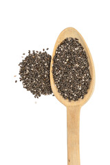 Close up of chia seeds on a wooden spoon with a pile next to it seen directly from above and isolated on white background