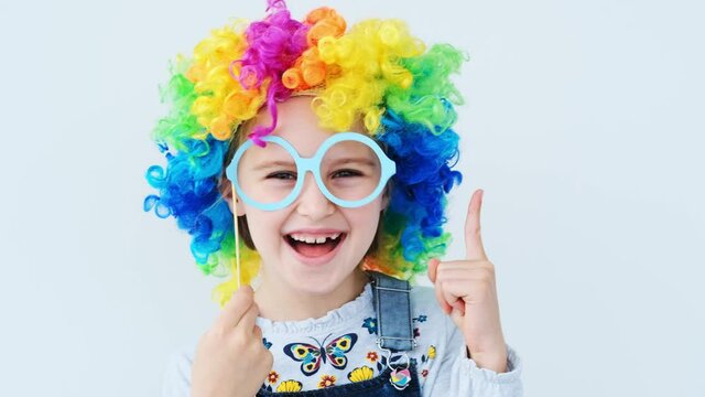 Cute child wearing rainbow wig with eyes