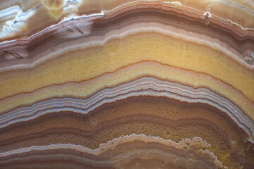 Yellow brownish natural onyx stone with white and red stripes