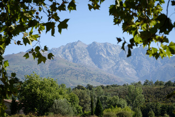 View from Candeleda of the Sierra de Gredos, Avila, Castilla Leon, Spain, Europe. Mountain framed among trees.