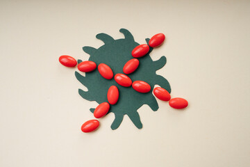 Red cross made of medicine pills over coronavirus.