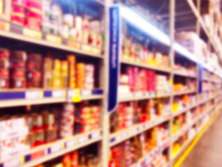 Fototapeta premium Abstract blurred supermarket store and refrigerators in department store. Interior shopping mall defocused background. Business food. Bokeh light background. Blur supermarket. Drink zone concept