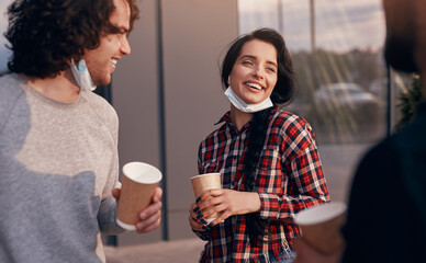 Happy woman speaking with colleagues during coffee break