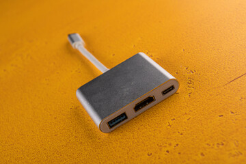 adapter for connecting the camera, computer and monitor are on the orange table