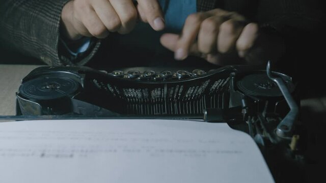Script writer prints the text on a typewriter