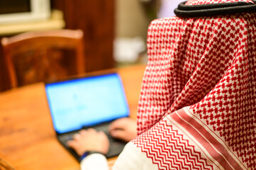 Arabic man from Saudi Arabia working at home to protect him self from the viruses pandemic COVID-19 "corona".