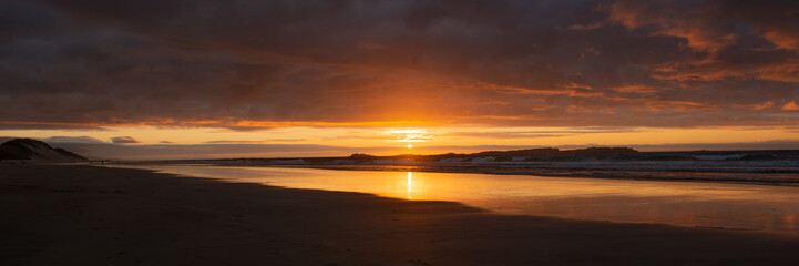 Naklejka na ściany i meble Sunset on the beach at White Rocks, Causeway Coast, Northern Ireland