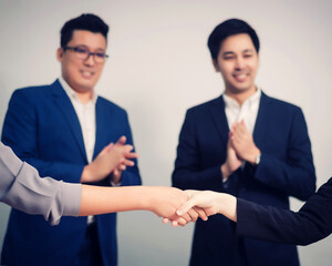 Business people shaking hands, between meeting in seminar room