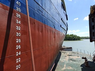 The ship is in dry dock. The ship's side after painting. Draft scale